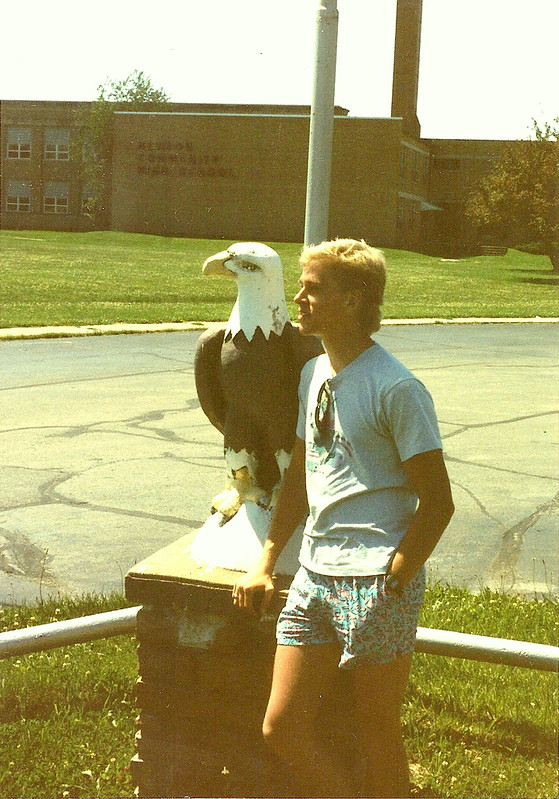 Sean poses with an eagle in front of Newton Community High School.