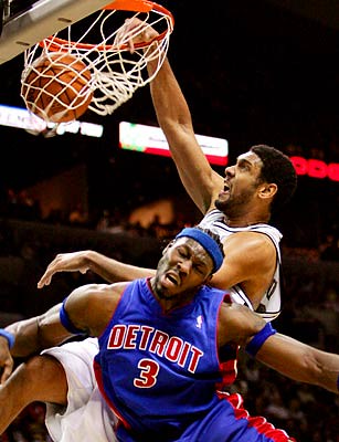 Los Angeles Lakers' Kobe Bryant, playing for the West All-Stars, reacts to  his dunk over Detroit Pistons' Grant Hill and San Antonio Spurs' Tim  Duncan, right, in the first half of the