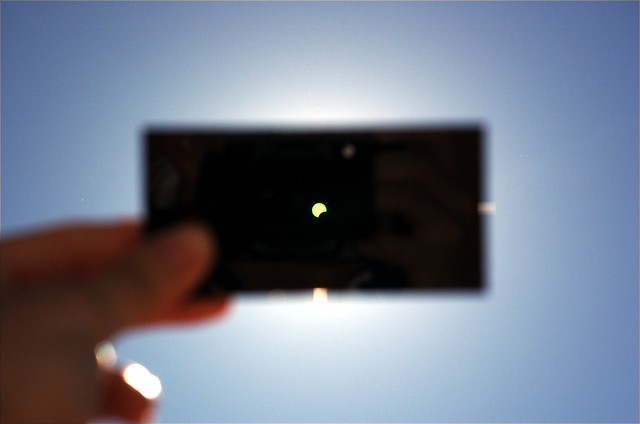An image of a solar eclipse being viewed through a (perhaps unapproved) solar filter.