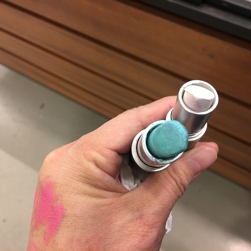 white and teal colored lipsticks