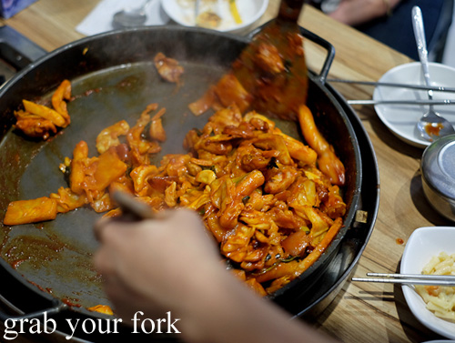Stirring and tossing the dakgalbi spicy chicken bbq at PR Korean Restaurant, Lidcombe