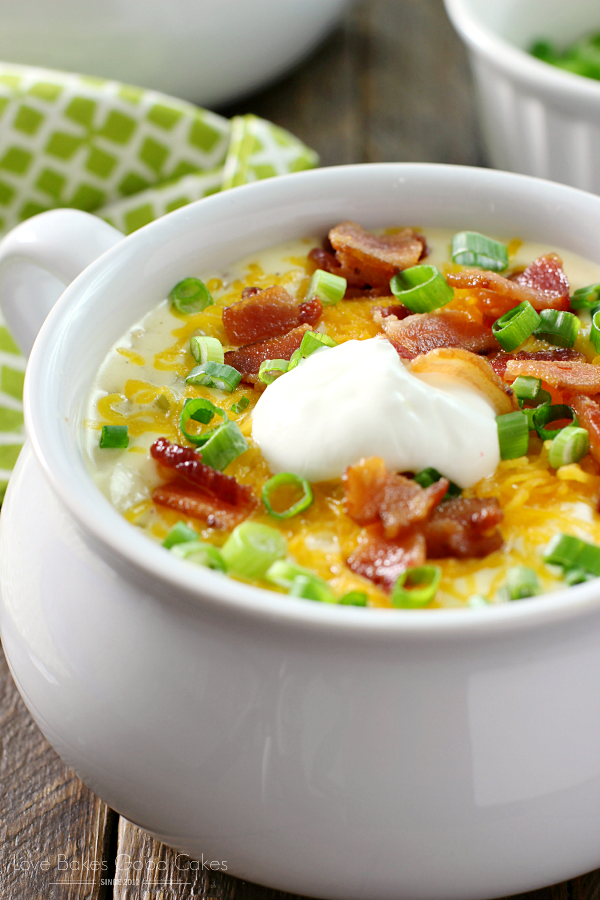 Loaded Baked Potato Soup in a white bowl close up.