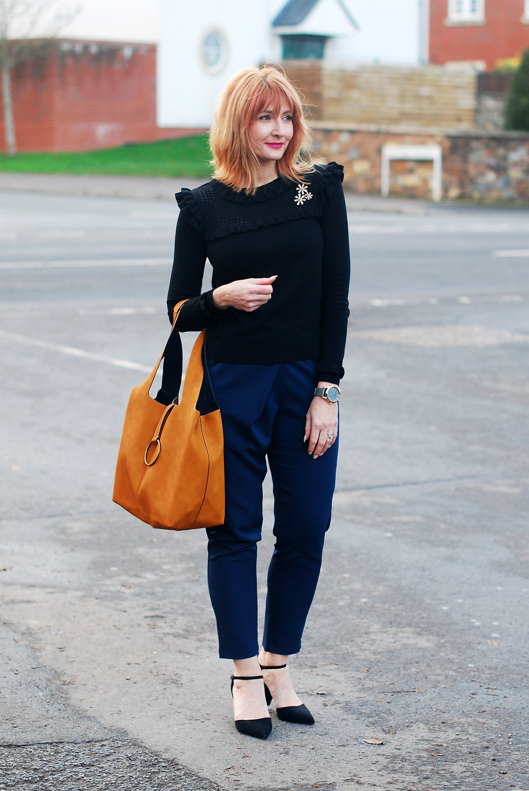 Navy and black together: Navy peg leg trousers black ruffled sweater black pointed heels mustard bucket bag | Not Dressed As Lamb, over 40 style