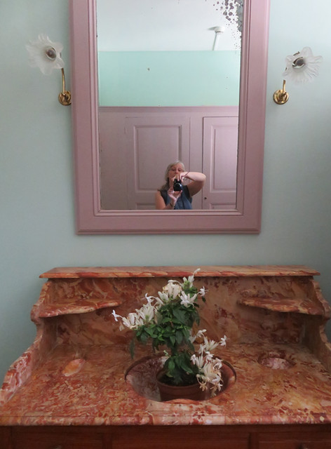 Taking a selfie in a mirror in Monet's home in Giverny
