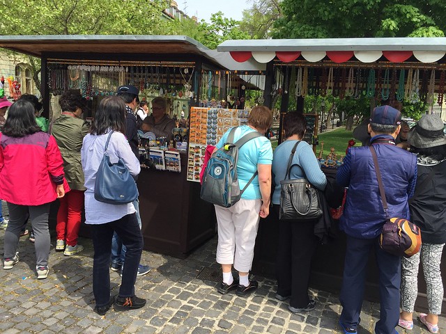 tourists buy souvenirs
