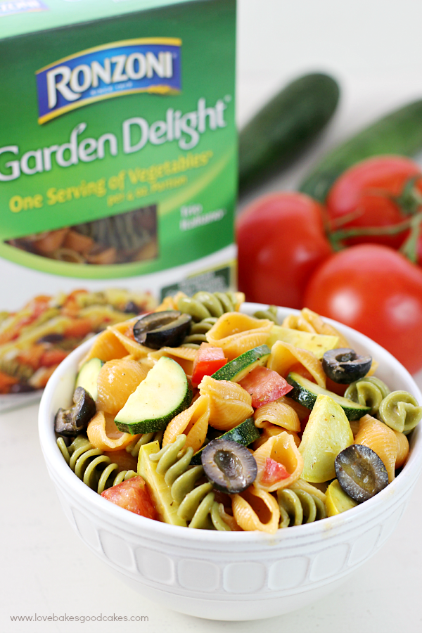 Summer Veggie Pasta Salad in a bowl with a package of Ronzoni Garden Delight.