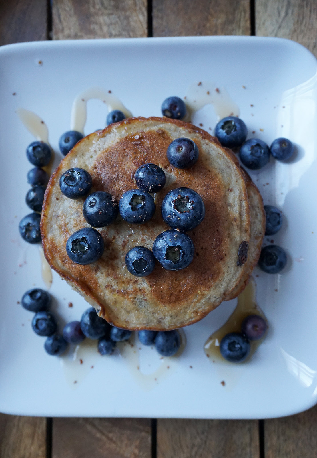Healthy and gluten free banana flaxseed pancakes with blueberries and maple syrup - made with Doves Farm gluten free self-raising flour