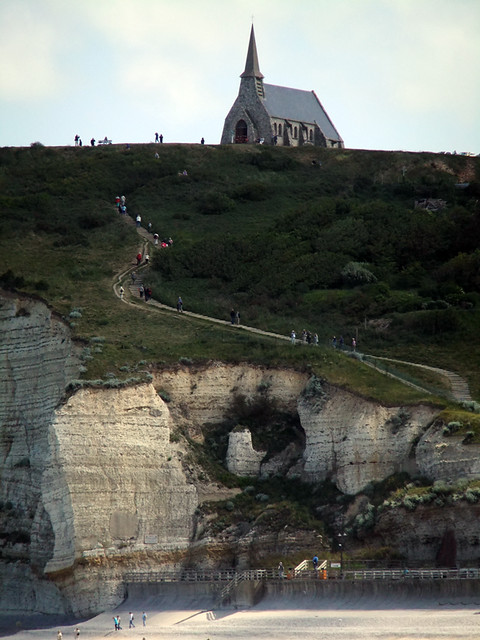 White rock formations on the Alabaster Coast of Normandy, France lead up to a church on the cliff
