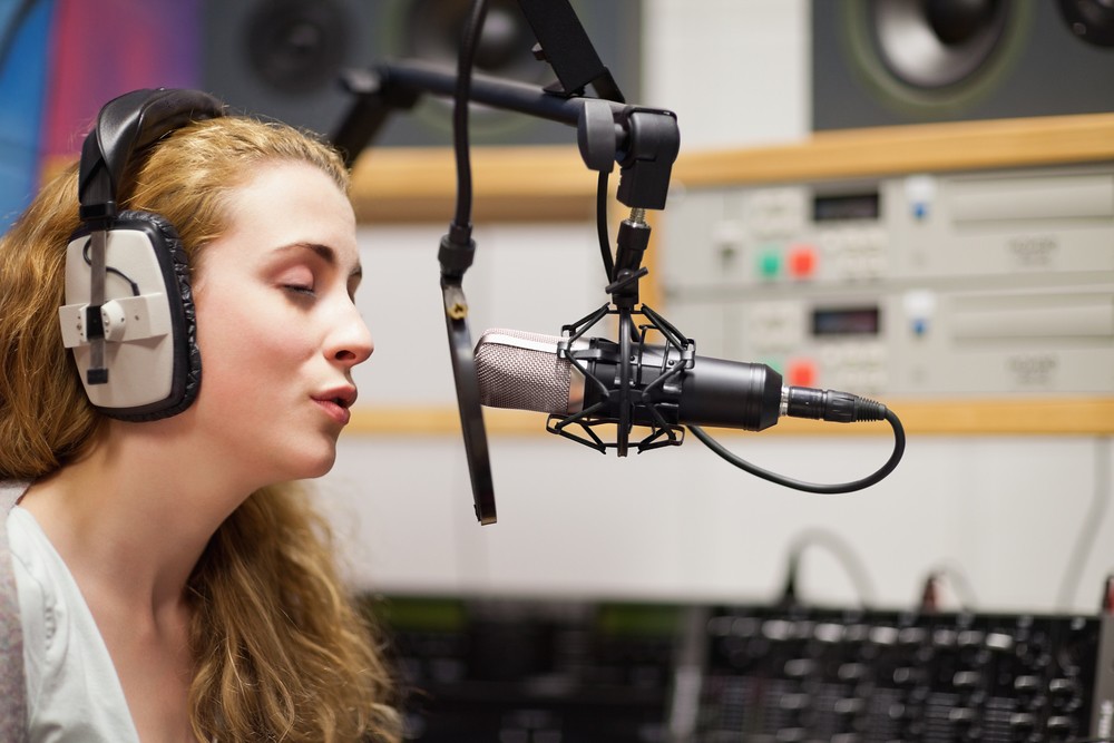 woman singing in recording studio