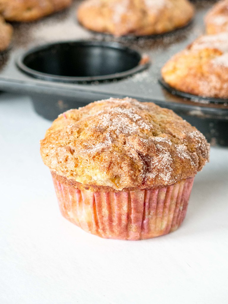 rhubarb muffins made with greek yogurt with a tray of muffins in the background