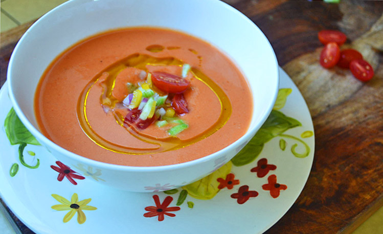 Chill gazpacho for at least 1 hour. Then pour smooth gazpacho into bowls and garnish with a drizzle of olive oil and finely chopped tomatoes, peppers and onion.