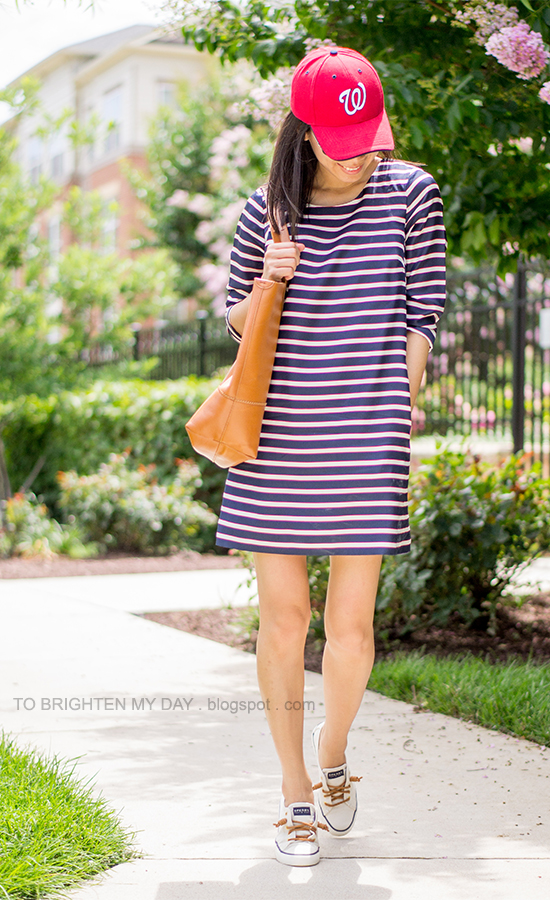 red cap, striped dress, cognac brown tote, boat shoes