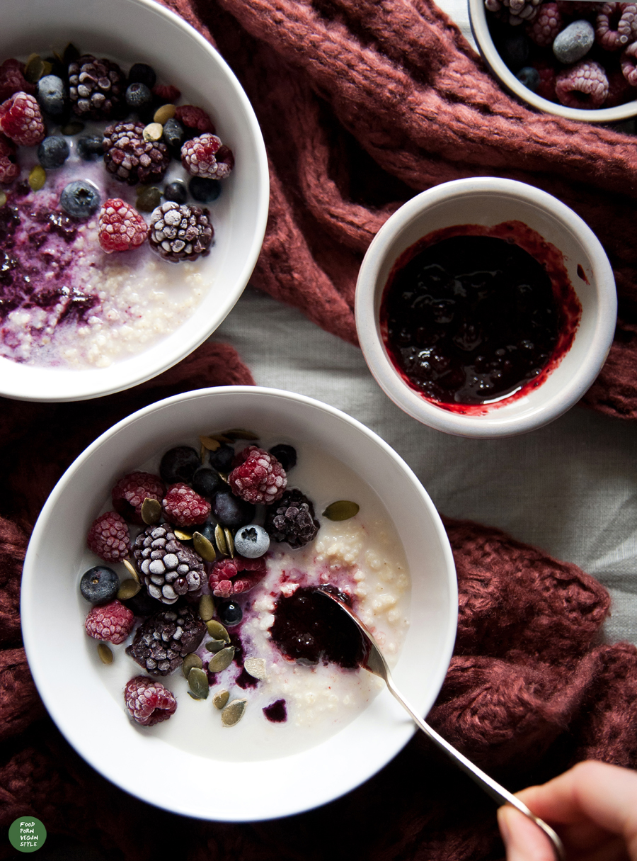 Millet porridge with a homemade blueberry jam, frozen fruits and hazelnut milk