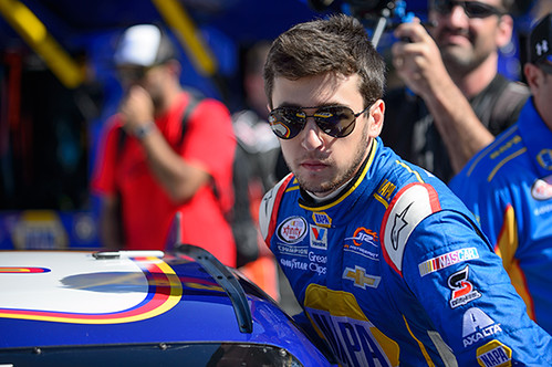 20-year-old Chase Elliott stands next to his car at a race.