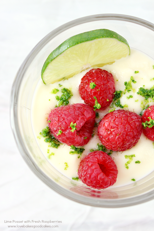 Lime Posset with Fresh Raspberries in a glass.