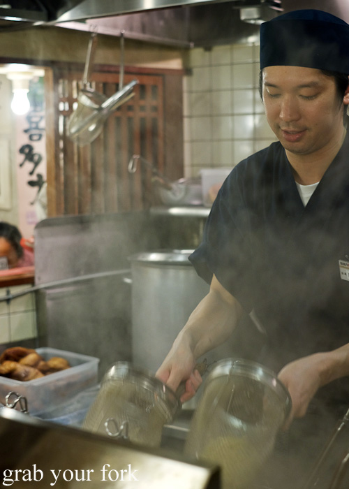 Draining the ramen noodles at Bannai Shokudo, Kyoto Ramen Street inside Kyoto station, Japan