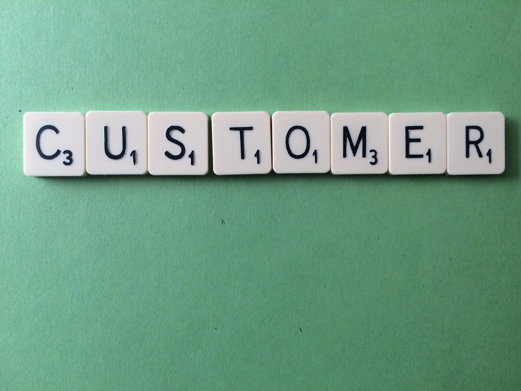 scrabble pieces spelling the word customer