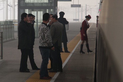 Smokers have a quick puff during the station stop at Handan East