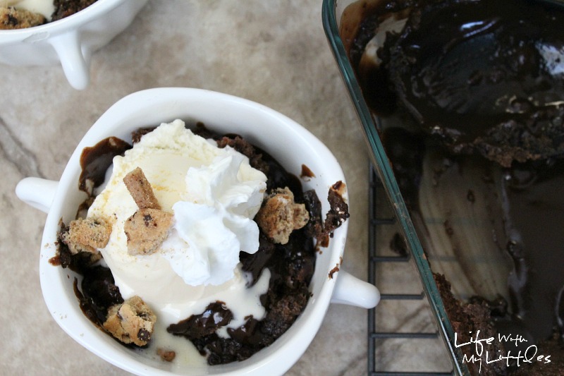 Super easy Hot Fudge Sundae Cake. It's the perfect summer dessert! A chocolate, fudgey cake topped with vanilla ice cream, whipped cream, and cookies! 