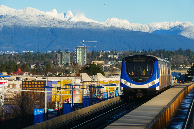 Canada Line Running Through Richmond and Vancouver City with Snow Capped Mountain Lions