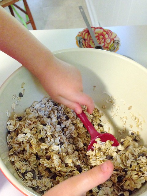 stirring up ingredients for chocolate chip granola bars