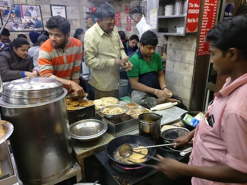 Can you spot the barefoot man making paranthas?