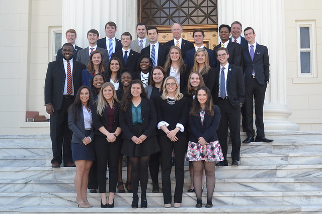 Approximately 30 Auburn students stand on the steps of the capitol building in Montgomery with Gov. Robert Bentley