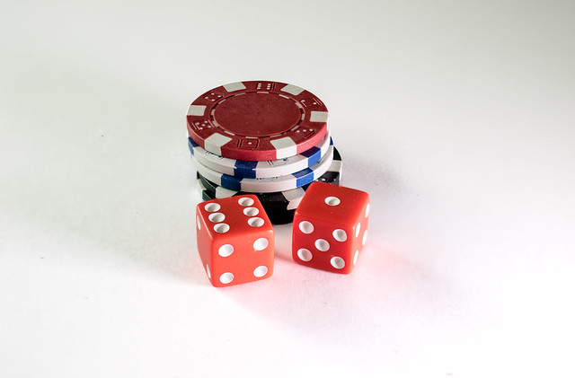 Gambling chips and dice on a white background