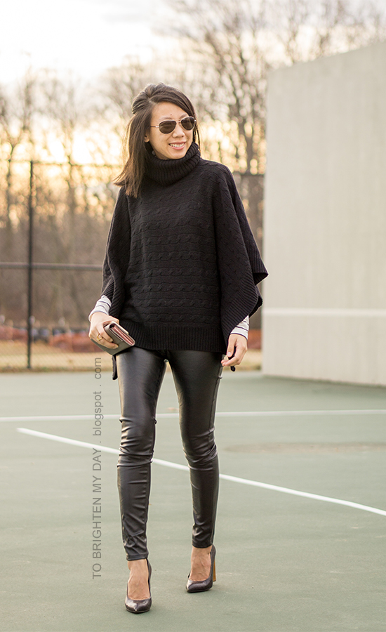 black turtleneck poncho, striped top, black faux leather pants, taupe clutch, black croc embossed pumps with wooden heels
