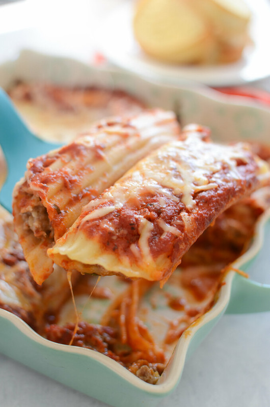Sausage Stuffed Manicotti - pasta filled with sausage and cheese and covered in sauce and more cheese. Total comfort food! 