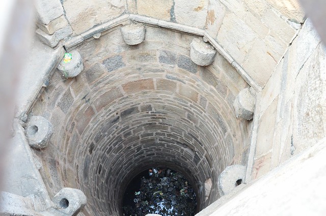 Water can still be seen at the bottom of the well, along with plastic and other garbage.(Source: IWP)