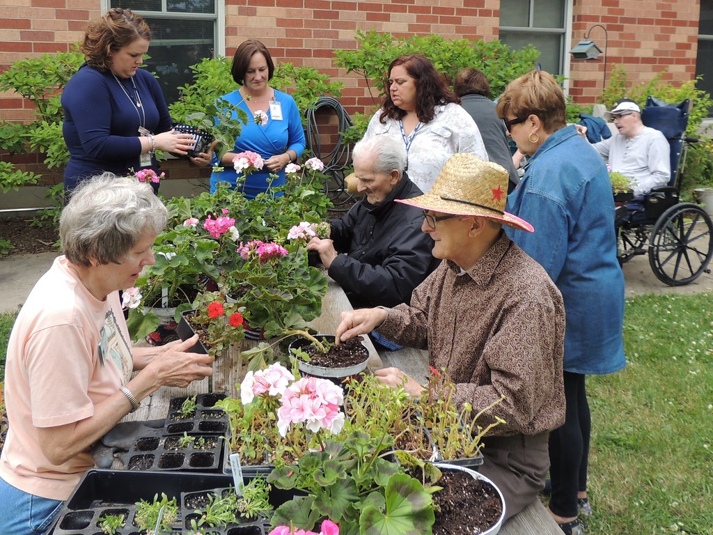 image of volunteers gardening with elders.
