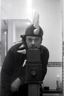 reflected self-portrait with Thornton Pickard Junior Special camera and dragon headress