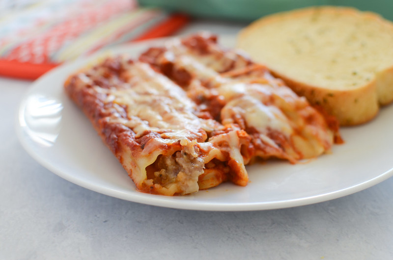 Sausage Stuffed Manicotti - pasta filled with sausage and cheese and covered in sauce and more cheese. Total comfort food! 