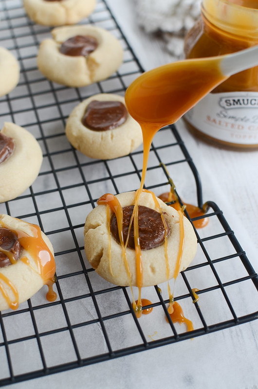 Salted Caramel Chocolate Thumbprints - shortbread cookies filled with Nutella and drizzled with caramel! Perfect for Christmas cookie tins!