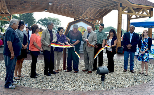 U.S. Dept. of Agriculture Rural Development State Director for Michigan James J. Turner (fifth from right) cutting the ribbon for the Mt. Pleasant Native Farmers Market with Saginaw Chippewa Indian Tribal Chief Steve Pego