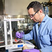 Explosives chemist David Chavez weighs a small amount of tetrazine, an explosives precursor. Chavez has synthesized two new explosives molecules that promise high-energy with enhanced safety.