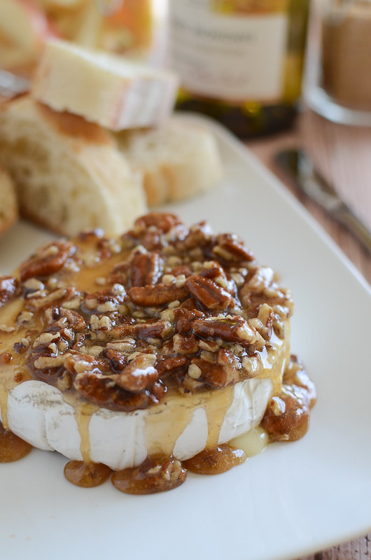 Maple Pecan Baked Brie - delicious melty brie topped with a maple, brown sugar, and pecan mixture. Serve with apple slices and graham crackers! Perfect holiday appetizer!