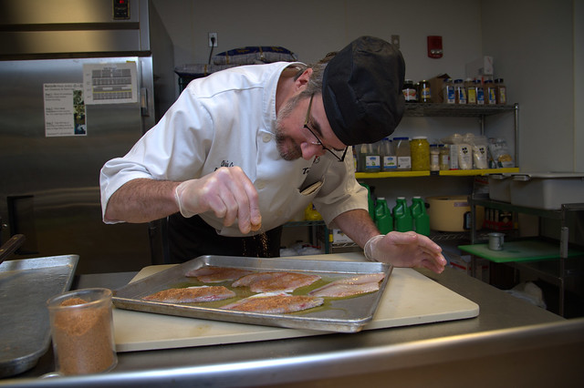 Executive Chef Chris Cox prepares tilapia that was harvested as part of the aquaponics initiative.