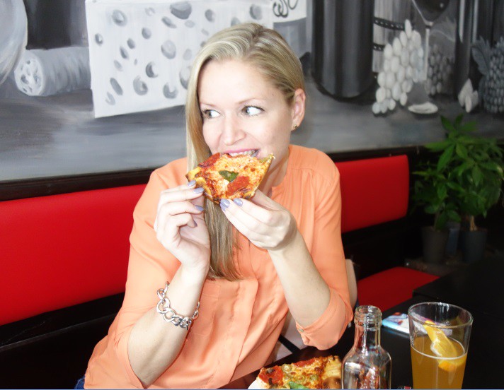Shannon Tebb eats thin crust pizza at Basso Pizzeria