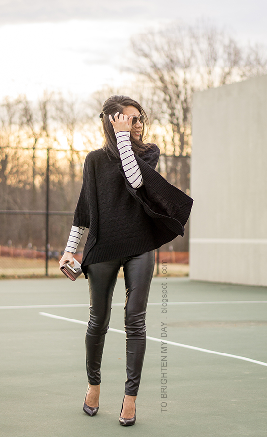 black turtleneck poncho, striped top, black faux leather pants, taupe clutch, black croc embossed pumps with wooden heels