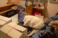 a cluttered room with moving boxes.