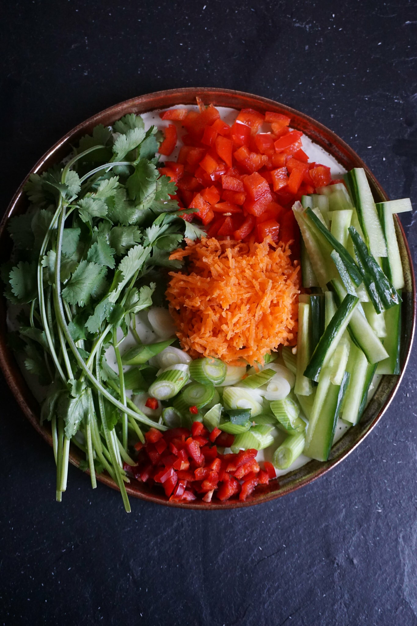 Toppings for gluten free Chinese crispy duck lettuce wraps - coriander, bell pepper, cucumber, chilli, spring onions and grated carrots
