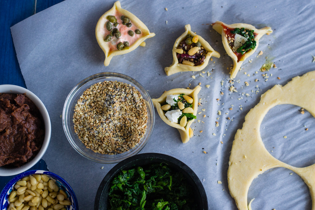 Savory hamantaaschen with six different 'around the world' fillings, including a pizza hamantaschen and so much more! 