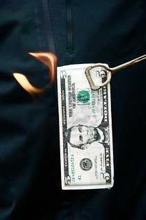 Burning five dollar bill