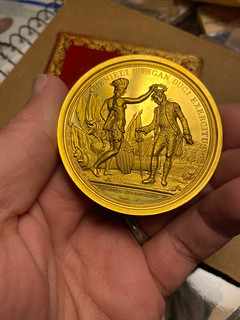 GOld Morgam medal in hand obverse