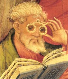 peering at book thru spectacles
