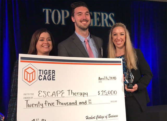 Dawn Michaelson, Matt Hanks and Sarah Gascon hold a giant check with 'Tiger Cage' on it