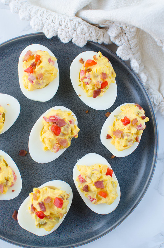 Bacon Pimento Cheese Deviled Eggs - a twist on the classic! Deviled egg filling is mixed with crispy bacon, cheddar cheese, and pimentos. So delicious and the perfect way to use all those Easter eggs!