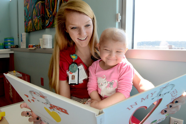 Lindsay Smith reads to a young patient.